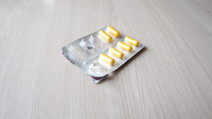 medical preparation in the form of yellow capsules in a package