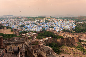 Fototapeta premium Top view of famous Mehrangarh fort, Jodhpur city in the background, as seen from top of the fort, Jodhpur, Rajasthan, India. Mehrangarh Fort is UNESCO world heritage site popular worldwide.