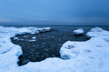 Wonderfully beautiful sunset by the sea in winter with ice