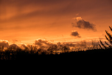 Fototapeta premium Dramatic clouds on the sky in red colors in the area called Rothaargebirge