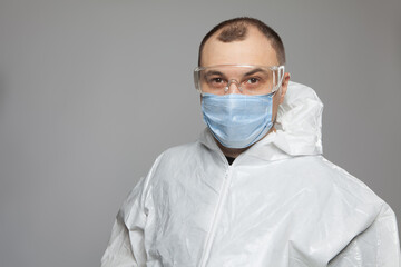 Scientific virologist. Biologist in protective suit and blue gloves. Viruses concept. Virus University employee.