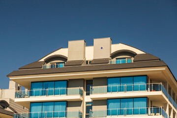 Close-up of a multi-apartment panel house with blue windows