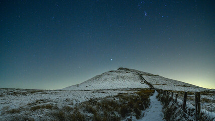 Orion astro star photo above snowy hill in winter
