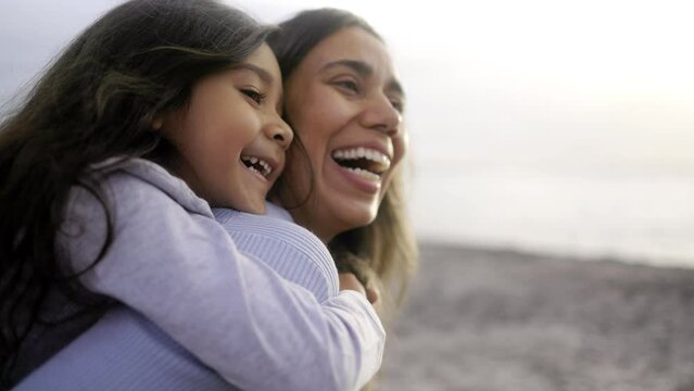 Hispanic mother and daughter having moment together outdoor - Family and love concept