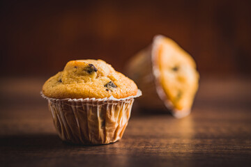 Sweet vanilla muffins on wooden table.