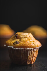 Sweet vanilla muffins on black table.