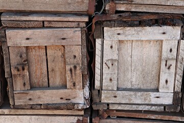 Old wooden boxes are stacked in the warehouse of village store