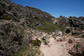 View of the empty hiking path across the rocky hills. 