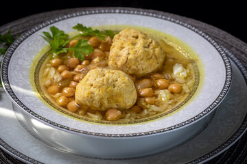 Persian chicken gondii soup with meatballs, hummus and rice.