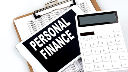 PERSONAL FINANCE text on a tablet with chart, calculator and pen