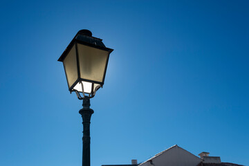 Fototapeta na wymiar Lantern style street lamp, against a blue sky.
