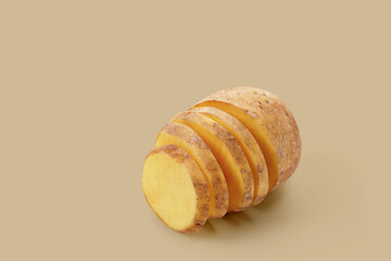 Potato slices on brown pastel background