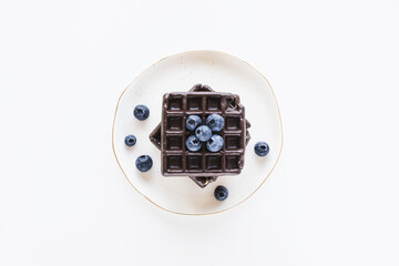 Belgian chocolate waffles from store on plate, white background