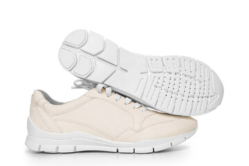 leather sneakers with lacing and perforated sole on a white background.