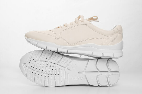 leather sneakers with lacing and perforated sole on a white background.