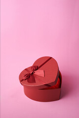 Heart shaped gift box on oink background