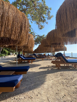 sunbeds, umbrellas and green lawns with sea view. Relaxation, sunbathing and rest area , selective focus blur, Antalya, &Ouml;l&uuml;deniz, Babadağ, 2022