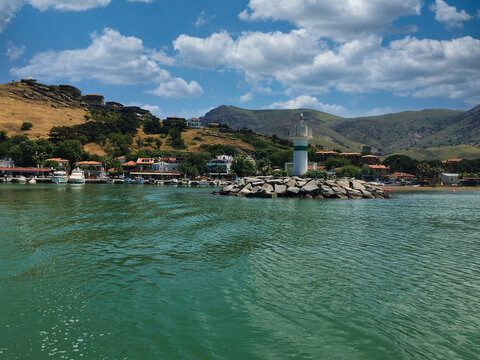 View of the town and the lighthouse from the sea of Gokceada Imbros island  kalekoy harbor. Kalekoy port view from sea of Imbros island in Canakkale Turkey