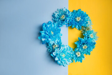 Blue and yellow background with blue flowers on it. Stand with Ukraine