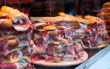 Traditional dish of Spanish province of Salamanca Bocadillos con jamon, sandwiches with jamon and cheese, at local eatery