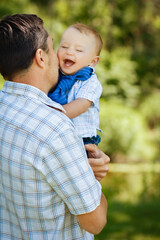 Happy parent with son outdoors in the park on nature journey