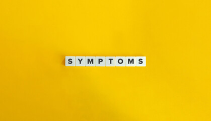 Symptoms Word on Block Letter Tiles on Yellow Background. Minimal Aesthetics.