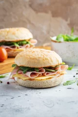 Foto op Aluminium Two homemade sandwiches with ham, cheese and arugula on a concrete table. © Vasiliy
