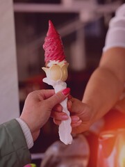 seller gives the ice cream in a waffle Cup