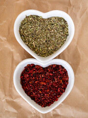 Mixture of Italian herbs and dried onions in heart shaped white bowls