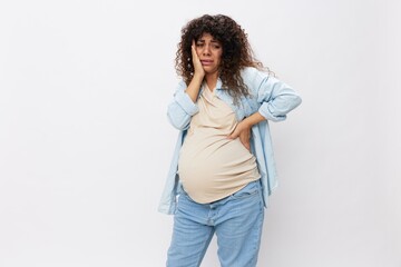 Pregnant woman tired, headache tears and frustration, difficult pregnancy, the last month before childbirth on a white isolated background in a T-shirt with a blue shirt