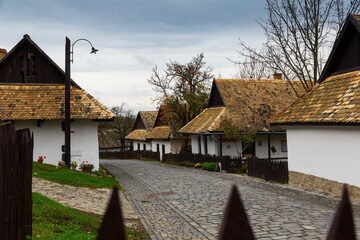 Fototapeta na wymiar Image of small houses in traditional hungarian village Holloke outdoors.