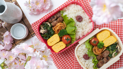 桜とお弁当と日本酒・お花見イメージ