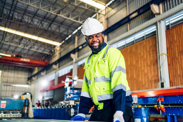 Professional labor machanic engineer technician worker industrial african black man wearing blue safety uniform working control with heavy machine in manufacturing  factory production line.industry