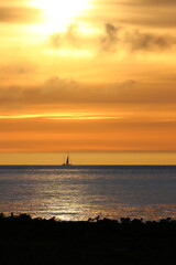 Fototapeta na wymiar Sailing in the sunset