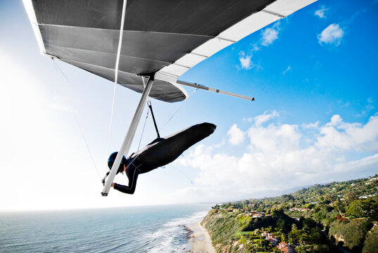Man hang-gliding over seashore, Wilcox, Santa Barbara, California, USA