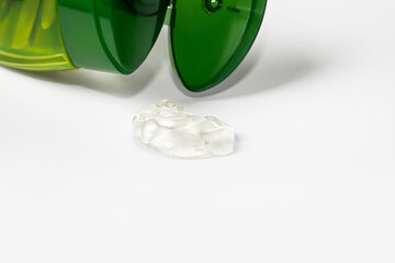 Aloe gel on a light background and a bottle of green.
