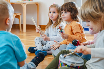 Preschool children with instruments in a music class - 566828778