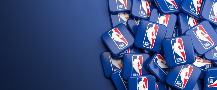 Logos of the American Basketball League NBA on a heap on a table.