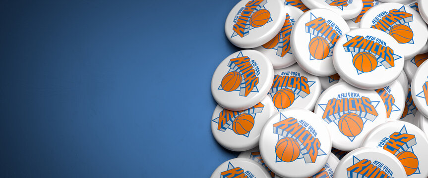 Logos of the American NBA Basketball Team New York Knicks on a heap on a table.