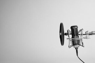 a microphone on gray background with copy space. podcasting background. 