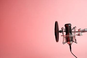 microphone on pink background with copy space for recording ,singing, podcasting concept.