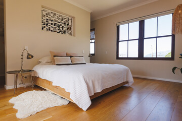 General view of luxury bedroom interior with bed and window