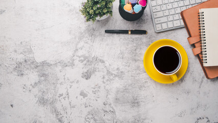 Office desk workplace with keyboard, notebook, pen and cup of coffee, Top viewflat lay with copy space.