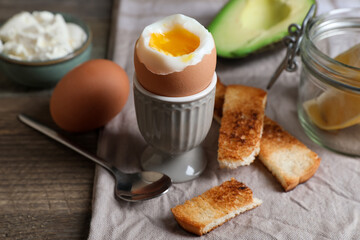 Soft boiled egg served for breakfast on wooden table