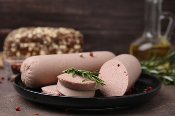 Delicious liver sausages with rosemary on brown textured table