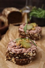 Delicious liverwurst sandwiches with pickled cucumber and mustard on table, closeup