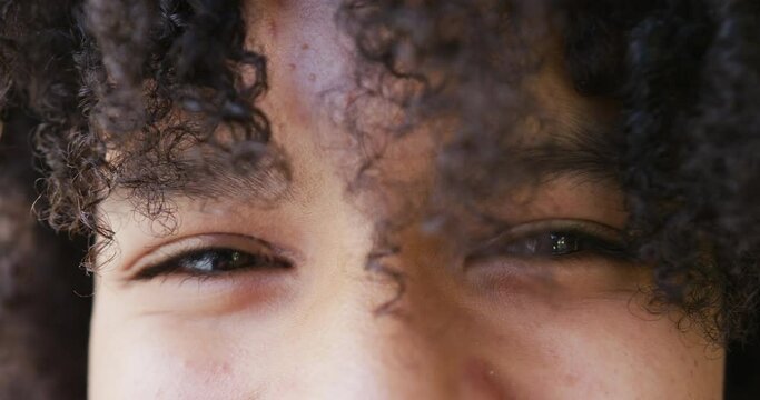 Portrait close up of the eyes of happy african american teenage girl smiling, slow motion