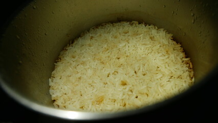  A rice pan, close-up shot. Making rice. Rice ready to eat. A rice pot, top angle. 