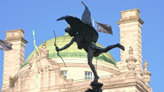 Statue of Eros, Piccadilly Circus, London. The familiar landmark set against a blue summer sky with copy space and multiple adds.