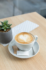 Cappuccino served on a wooden table